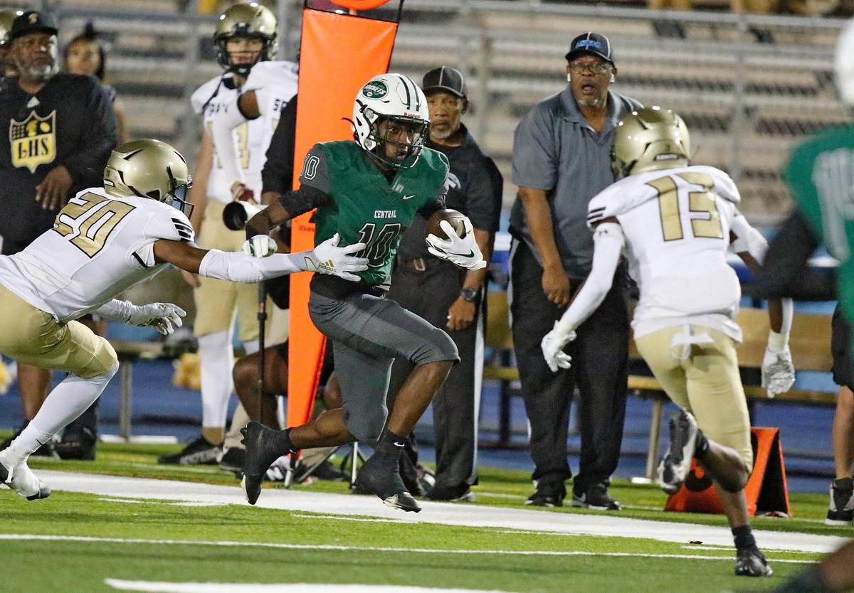 Miami Central Rockets wide receiver Cataurus Hicks (10) tries to escape St. Petersburg Lakewood Spartans defenders during Class 2M state semifinal game on Friday, December 2, 2022 at Traz Powell Stadium in Miami. Andrew Uloza / for Miami Herald