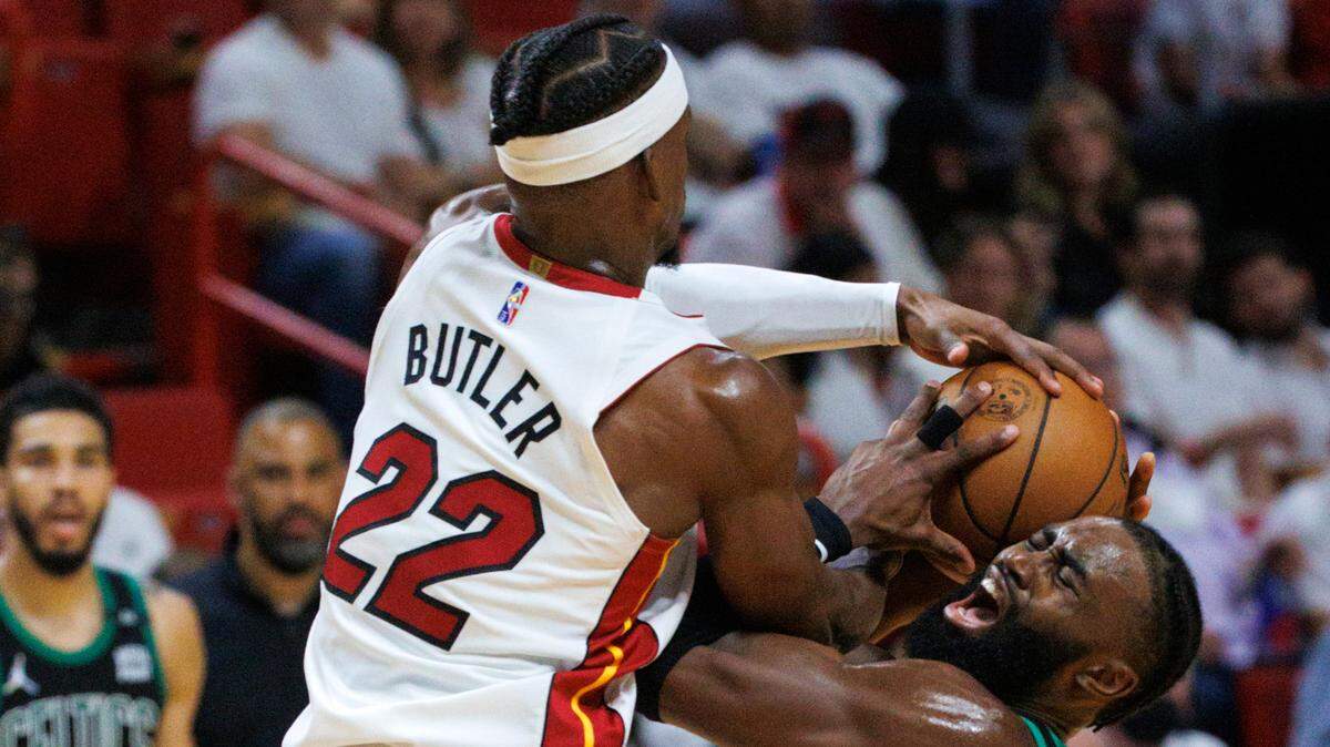 Miami Heat forward Jimmy Butler (22) blocks a shot against Boston Celtics guard Jaylen Brown (7) during the third quarter of Game 5 of the NBA Eastern Conference Finals series at FTX Arena in Miami, Florida, on Wednesday, May 25, 2022.