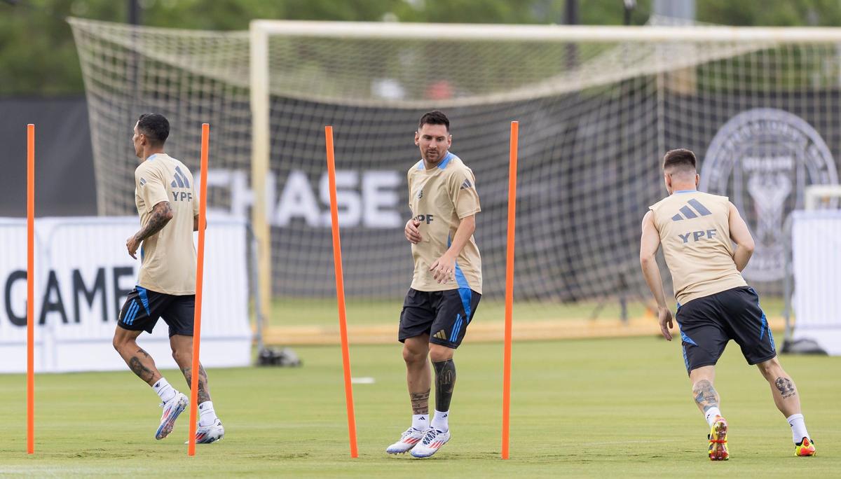 Argentina’s forward Lionel Messi, center, runs drills with his teammates .