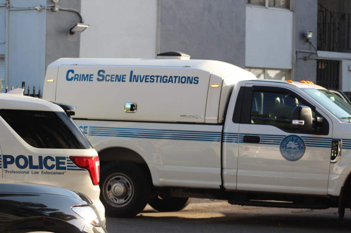 Miami police officers gather outside the Miami Riverfront Residences at 2601 NW 16th Street Road Wednesday, May 7, 2025. Police helped Suffolk County Police detectives conduct a search warrant at a unit there in connection with a Long Island homicide.