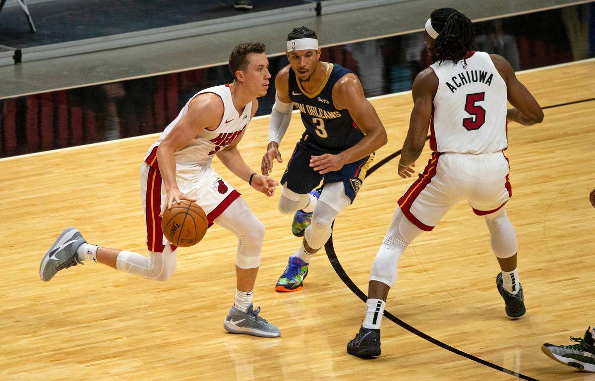 Miami Heat forward Duncan Robinson (55) drives against New Orleans Pelicans guard Josh Hart (3) in the third quarter of an NBA basketball preseason game at AmericanAirlines Arena on Monday, Dec. 14, 2020.