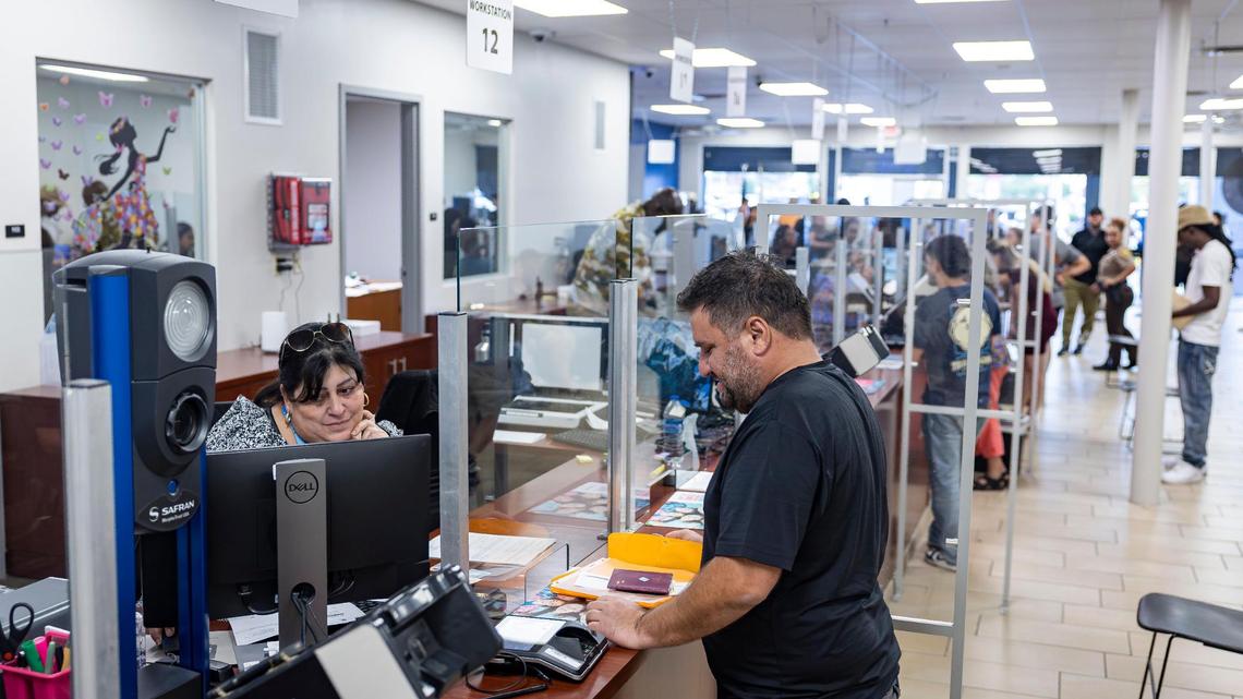 File photo of a customer being assisted at a DMV office on Wednesday, April 16, 2025, in Miami, Florida. The Tax Collector’s Office will offer driver’s licenses at a new location in Coral Gables.