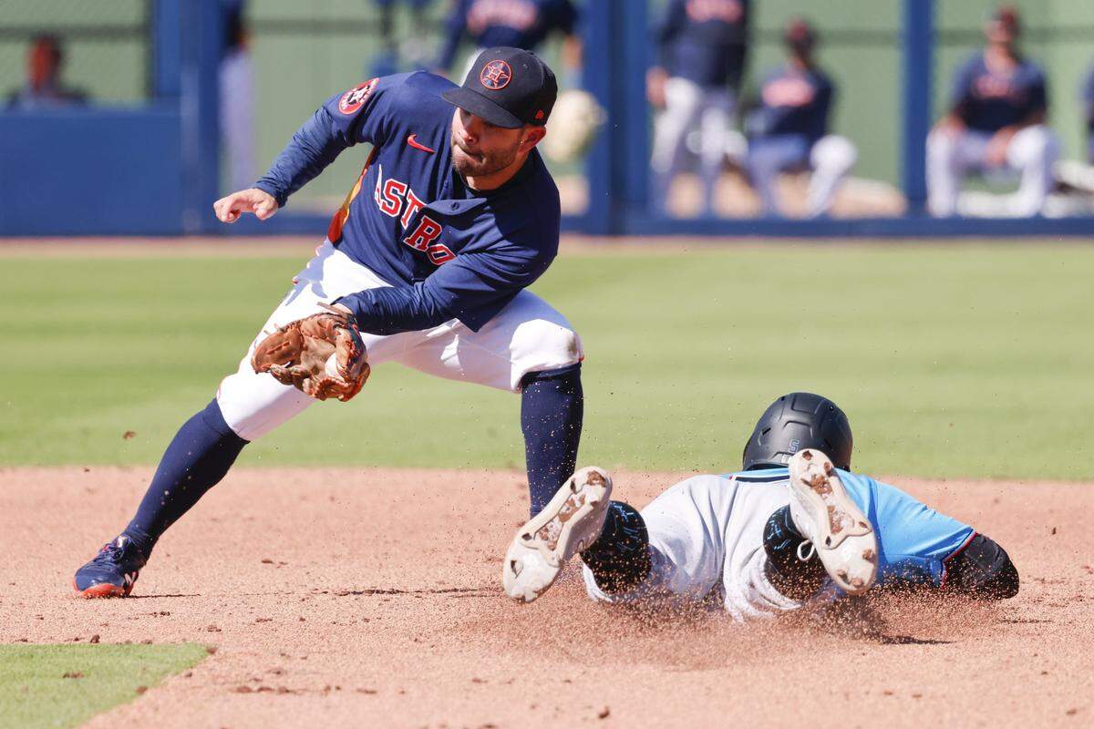 Feb 27, 2023; West Palm Beach, Florida, USA; Miami Marlins second baseman Jon Berti (bottom) slides safely into second base ahead of the tag from Houston Astros second baseman Jose Altuve (27) during the fifth inning at The Ballpark of the Palm Beaches. Mandatory Credit: Reinhold Matay-USA TODAY Sports