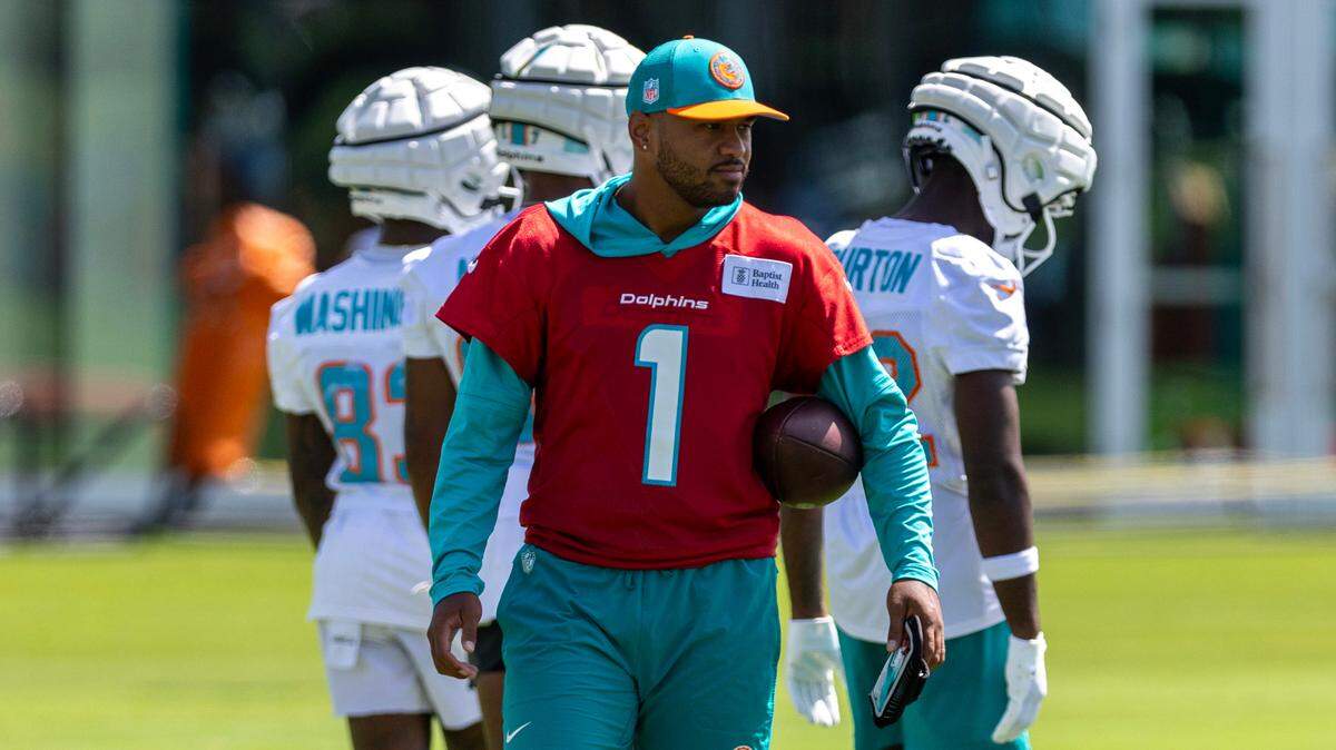Miami Dolphins quarterback Tua Tagovailoa looks on as teammates run drills during training camp at Baptist Health Training Complex on Thursday, July 25, 2024, in Miami Gardens, Fla.