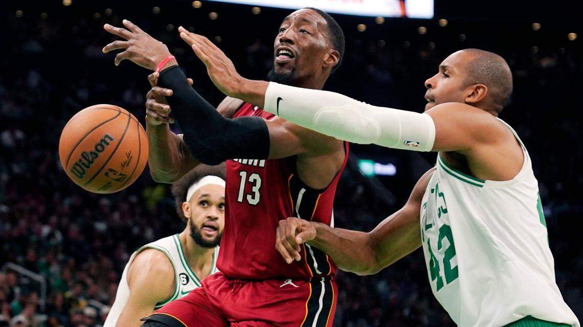 Boston Celtics center Al Horford (42) knocks the ball from Miami Heat center Bam Adebayo (13) during the second half of an NBA basketball game Wednesday, Nov. 30, 2022, in Boston.