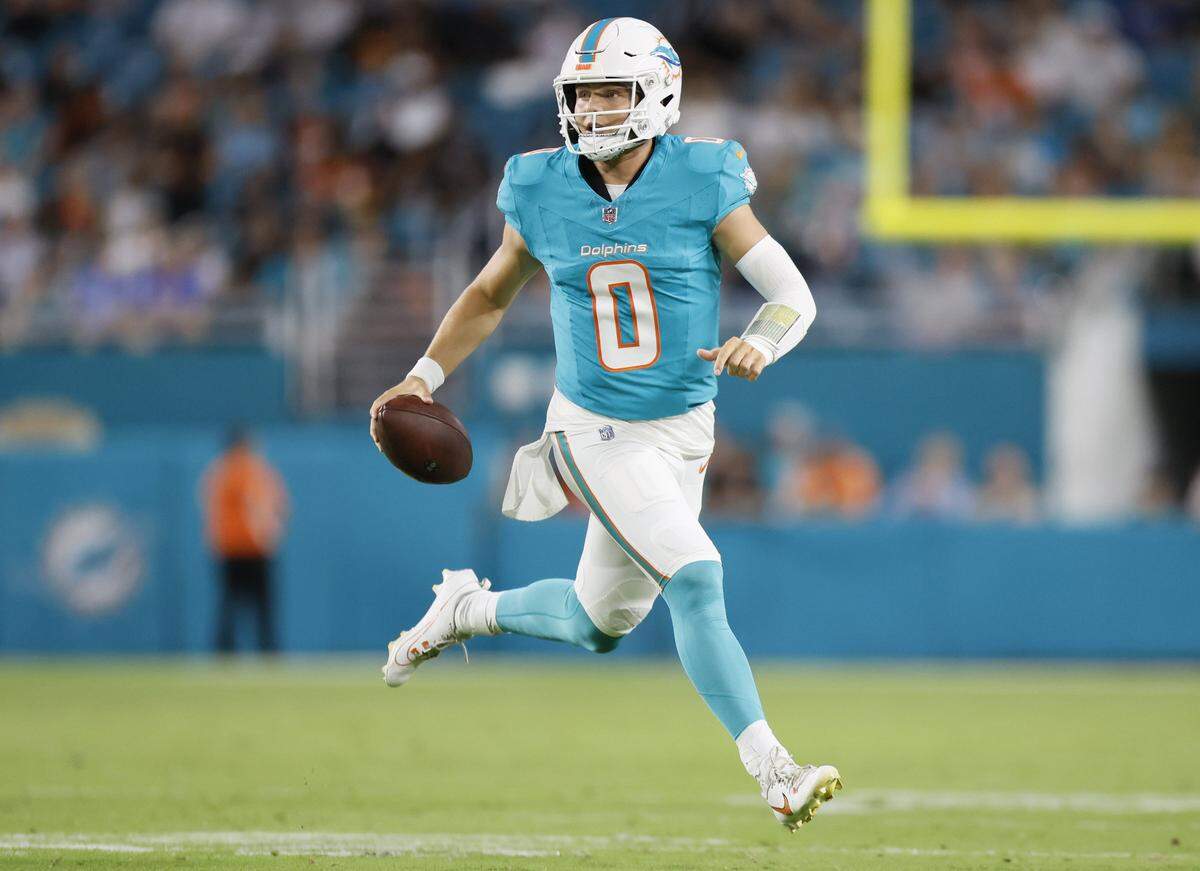 Miami Dolphins quarterback Zach Wilson (0) scrambles in the second quarter during an NFL football game against the Jacksonville Jaguars at Hard Rock Stadium in Miami Gardens, Florida, on Saturday, August 23, 2025. 