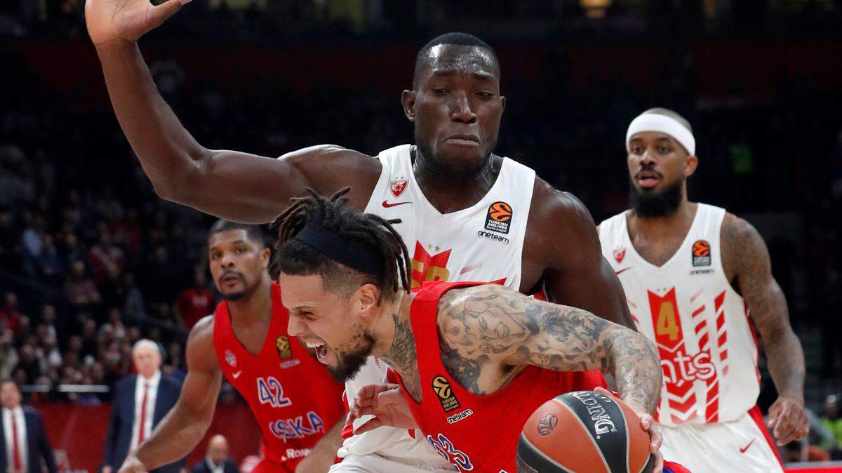 In this photo taken Friday, Feb. 21, 2020, CSKA Moscow’s Daniel Hackett, front, drives to the basket as Red Star’s Michael Ojo blocks him during their Euroleague basketball match in Belgrade, Serbia. Former Florida State center Michael Ojo has died after collapsing during training in Serbia. Serbian Media and his former teammates say the 27-year-old Nigerian-born basketball player was on Friday taken to a hospital in the Serbian capital, but doctors failed to reanimate him.
