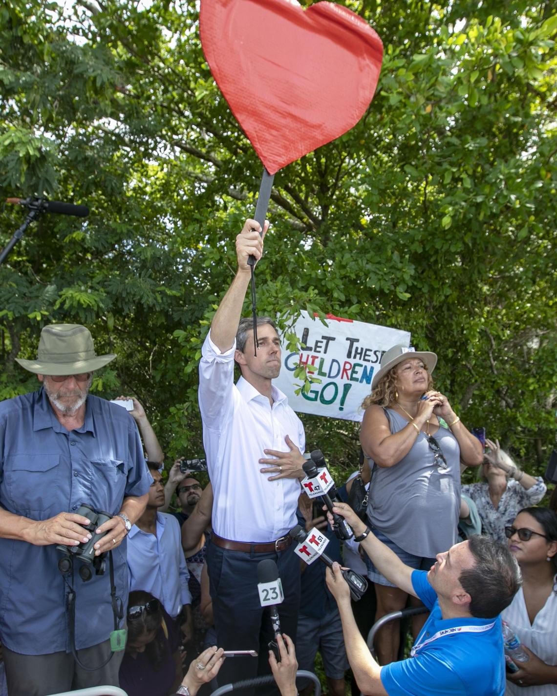 Democratic presidential candidate Beto O’Rourke shouts for the attention of the migrant children in the shelter across the street in Homestead on June 27, 2019.