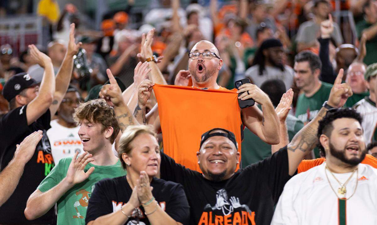 Fans cheer after Miami Hurricanes running back Jordan Lyle (21) scored a touchdown against the South Florida Bulls in the second half of their NCAA college football game at the Raymond James Stadium on Saturday, Sept. 21, 2024, in Tampa, Fla.