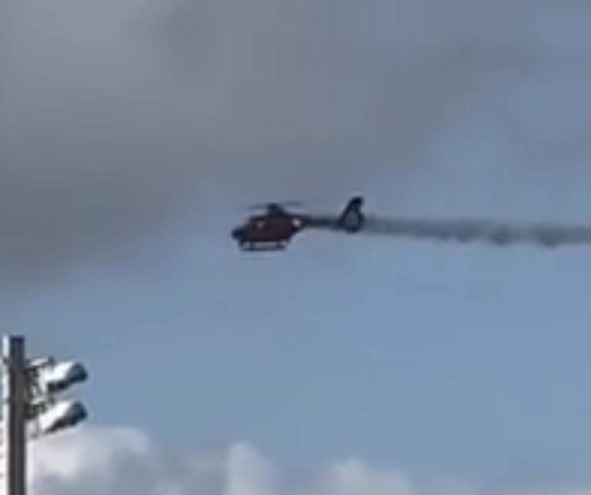 Smoke trails from the tail of a Broward Sheriff’s Office Fire-Rescue helicopter before it crashed in Pompano Beach Monday, Aug. 28, 2023.