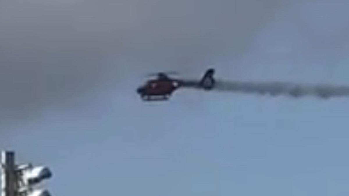 Smoke trails from the tail of a Broward Sheriff’s Office Fire-Rescue helicopter before it crashed in Pompano Beach Monday, Aug. 28, 2023.
