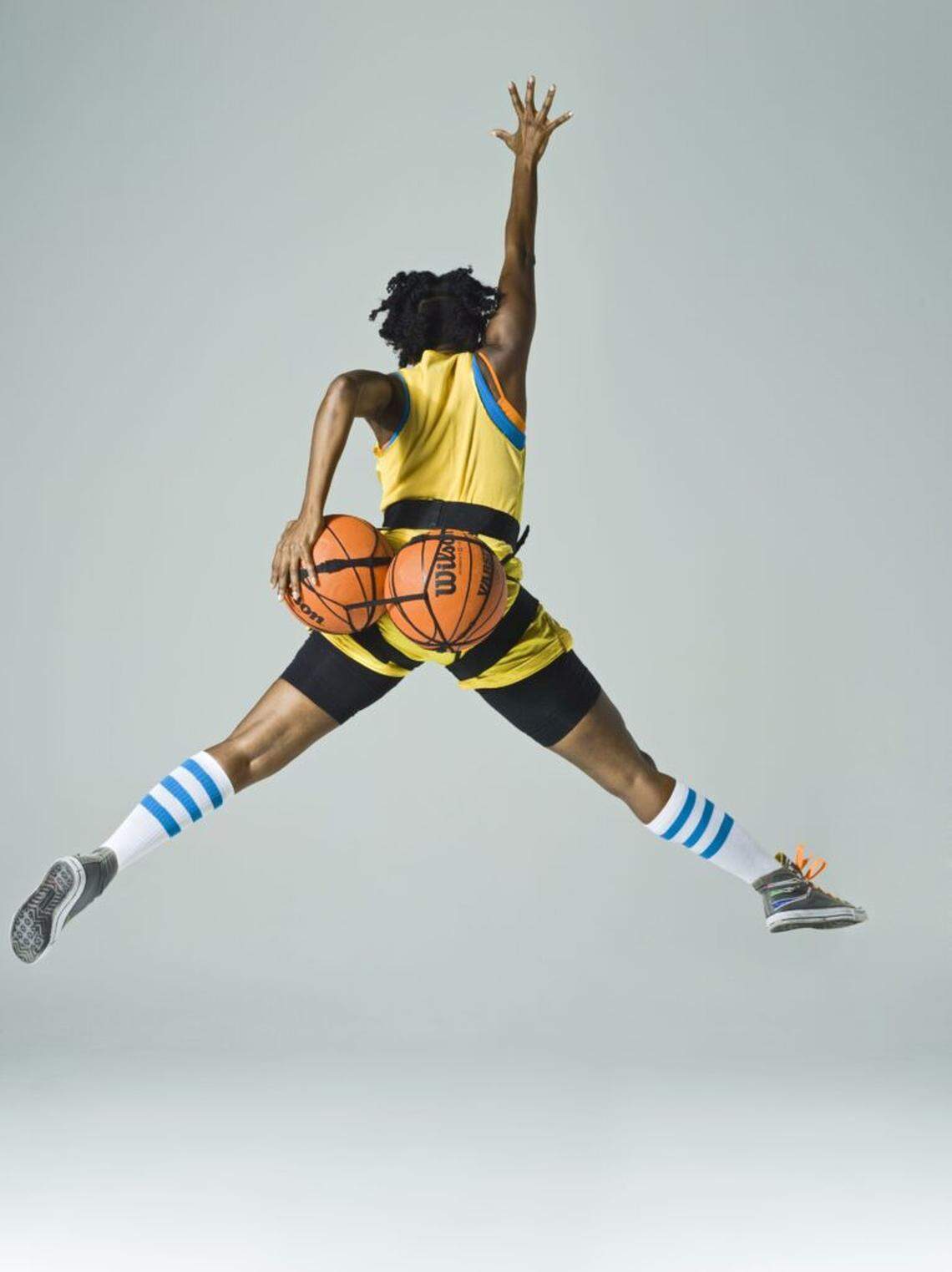 Holly Bass’ “NWBA (jordan)” 2012 freezes the artist in midair, her silhouette transformed through the incorporation of basketballs in a photograph.