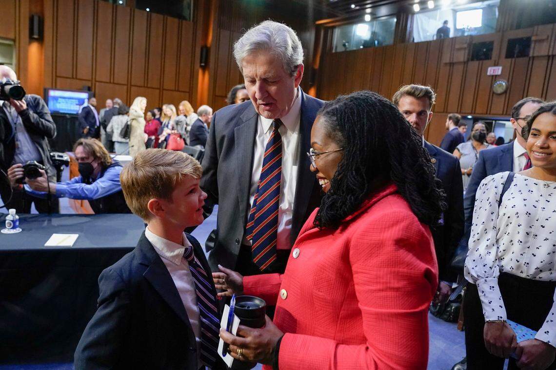 Sen. John Kennedy, R-Louisiana, center, and Supreme Court nominee Ketanji Brown Jackson talk with Owen Stokes, 6, son of Kennedy’s chief of staff, David Stokes, during a break in a Senate Judiciary Committee confirmation hearing for Jackson on Capitol Hill in Washington, Tuesday, March 22, 2022. Jackson’s daughter Leila Jackson looks on at right. 