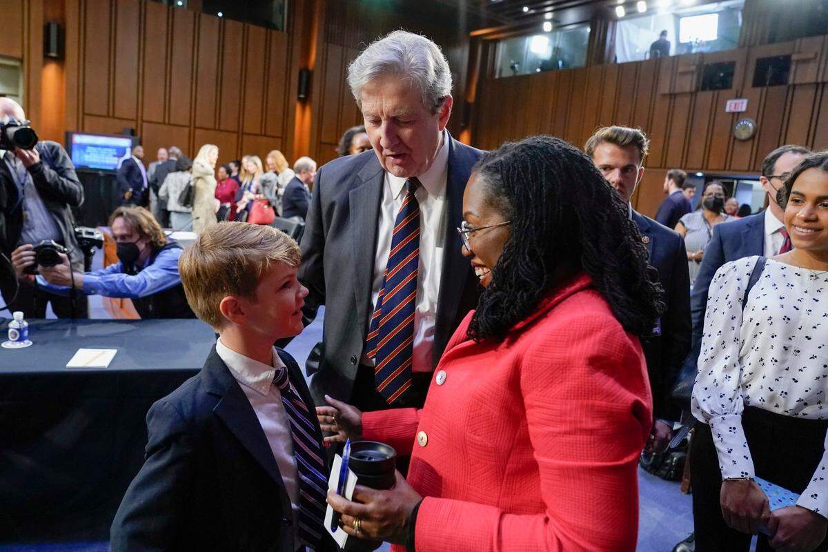 Sen. John Kennedy, R-Louisiana, center, and Supreme Court nominee Ketanji Brown Jackson talk with Owen Stokes, 6, son of Kennedy’s chief of staff, David Stokes, during a break in a Senate Judiciary Committee confirmation hearing for Jackson on Capitol Hill in Washington, Tuesday, March 22, 2022. Jackson’s daughter Leila Jackson looks on at right. 