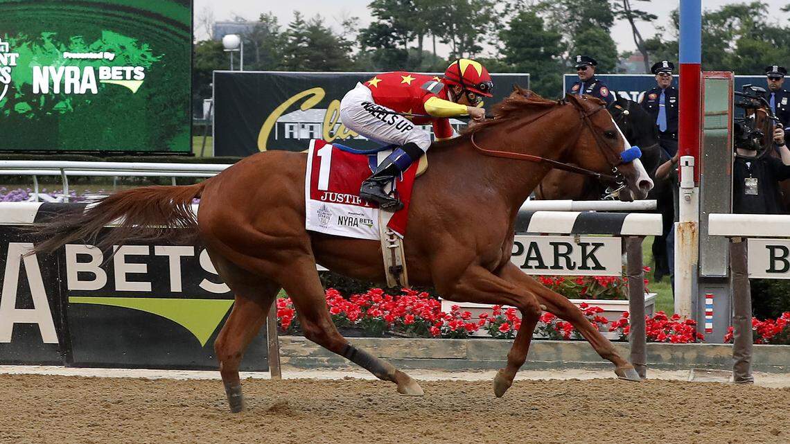 Justify (1), with jockey Mike Smith up, crosses the finish line to win the 150th running of the Belmont Stakes horse race, Saturday, June 9, 2018, in Elmont, N.Y. (AP Photo/Julie Jacobson)