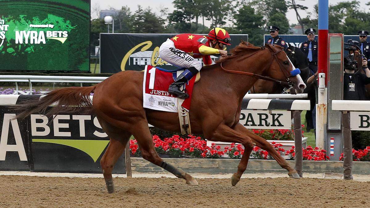 Justify (1), with jockey Mike Smith up, crosses the finish line to win the 150th running of the Belmont Stakes horse race, Saturday, June 9, 2018, in Elmont, N.Y. (AP Photo/Julie Jacobson)