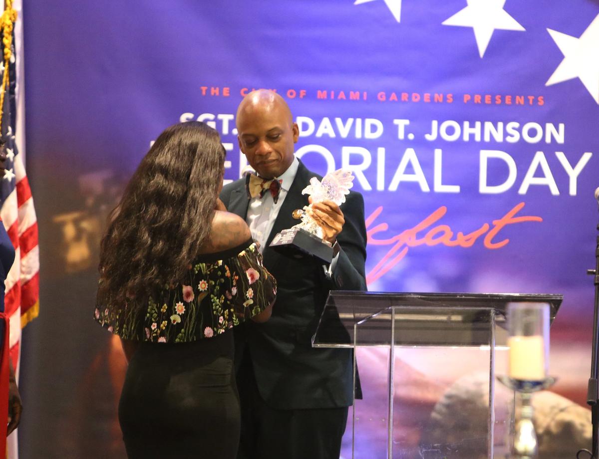 Myeshia Johnson, widow of Army Sgt. La David T. Johnson of Miami Gardens, is presented with a special award from Miami Gardens Mayor Oliver Gilbert during a Memorial Day breakfast named in honor of Johnson.