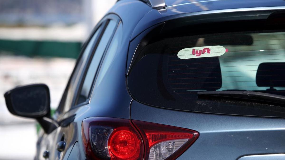 The Lyft logo is displayed on a car on March 11 in San Francisco. On-demand transportation company Lyft is expected to list its stock on the NASDAQ Stock Exchange beginning March 29.