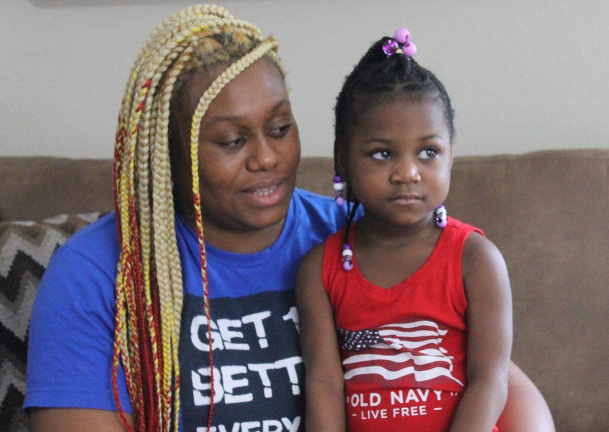 Serenity Toomer, 4, sits on her mother Tiffany’s lap inside their house in Homestead Wednesday, Nov. 24, 2020.