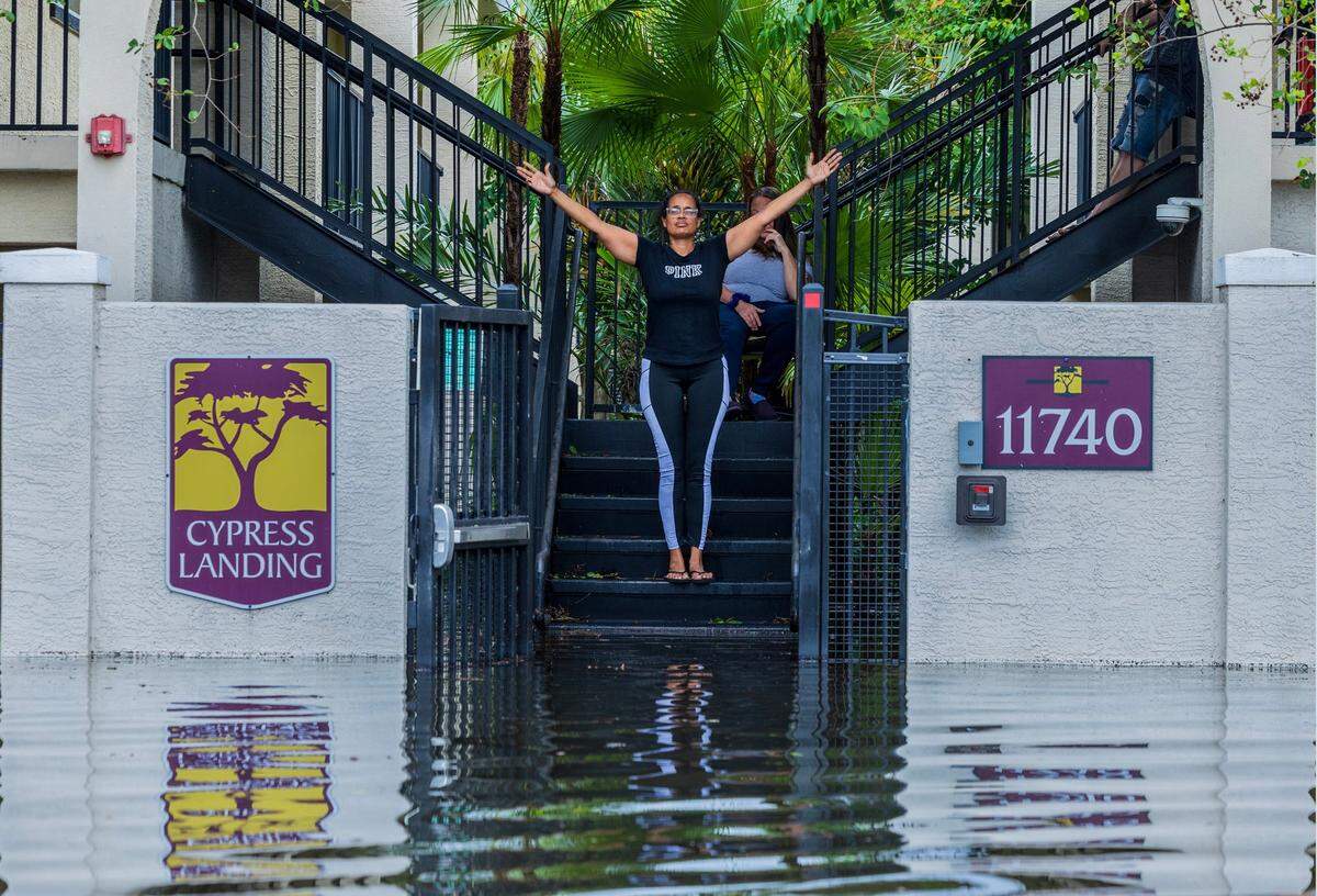 Keisha Jones resident of Cypress Landing reacts to the flooding surrounding her home at N 15th St in North Tampa, Thursday, October 10, 2024, a day after Hurricane Milton crossed Florida’s Gulf Coast.