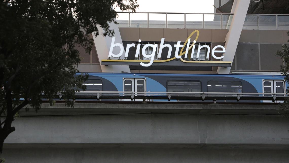 A Metrorail passenger train rolls by the Brightline terminal in downtown Miami in March.