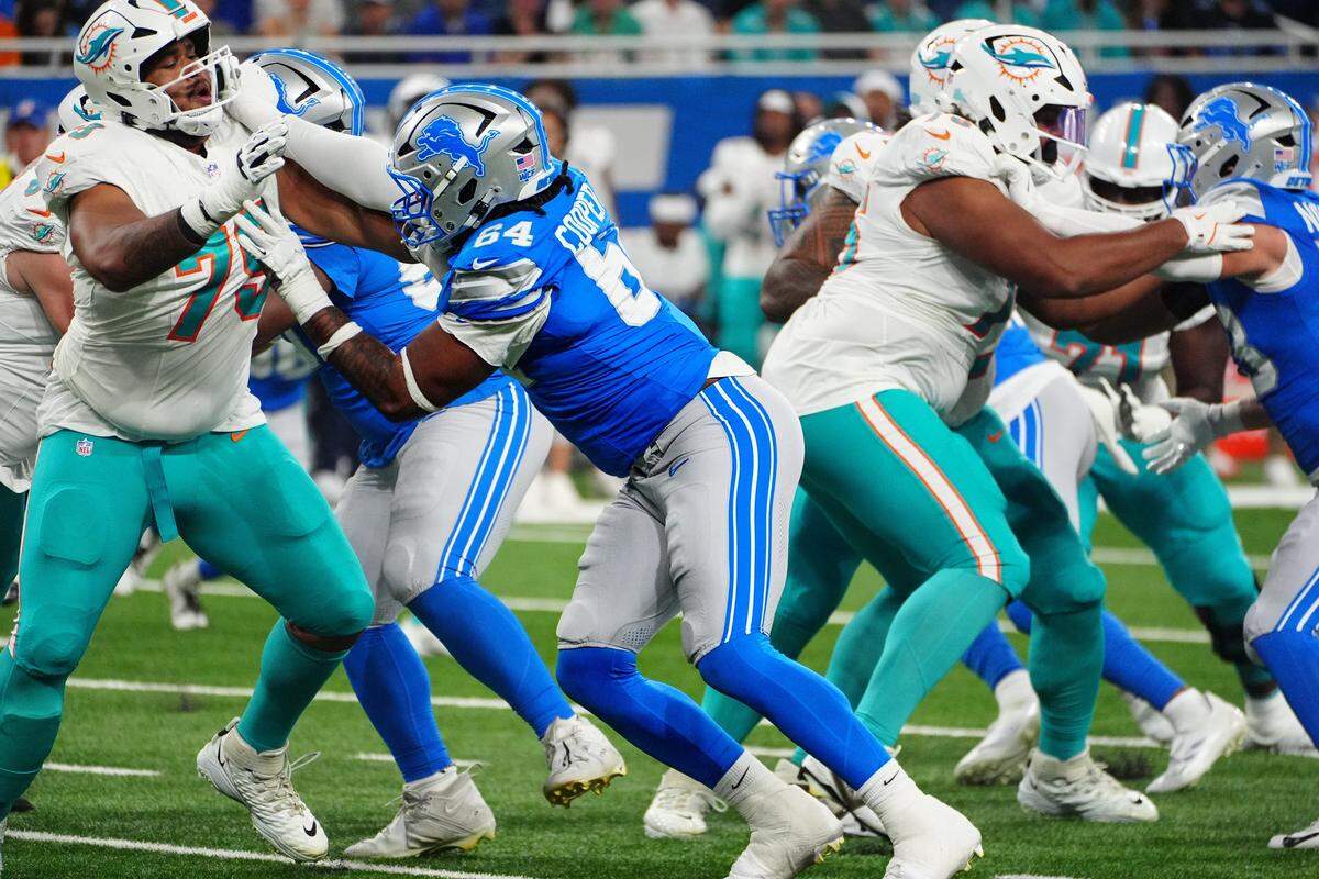 Detroit Lions defensive lineman Keith Cooper Jr. (64) pushes back against Miami Dolphins offensive tackle Jalen McKenzie (75) during the first quarter of the preseason game at Ford Field in Detroit, Saturday, Aug. 16, 2025.