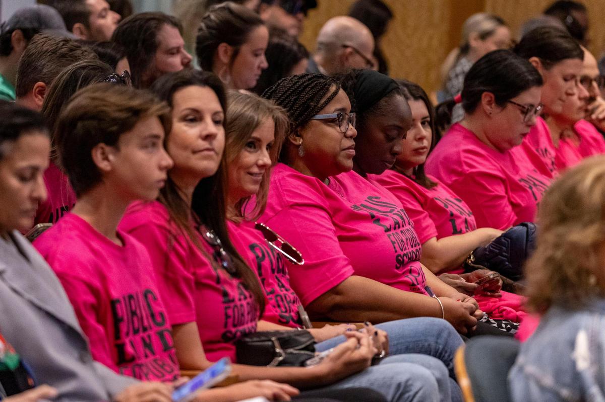 Supporters of iPrep Academy wearing magenta T-shirts sit inside Miami City Commission chambers during a meeting on March 14, 2024.