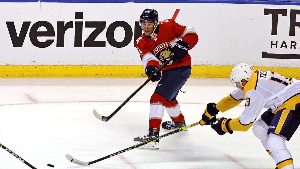 Florida Panthers right wing Justin Sourdif (24) passes the puck against Nashville Predators center Yakov Trenin (13) during the third period of game one of their doubleheader preseason NHL hockey game at FLA Live Arena on Sunday, September 26, 2021 in Sunrise, Florida.