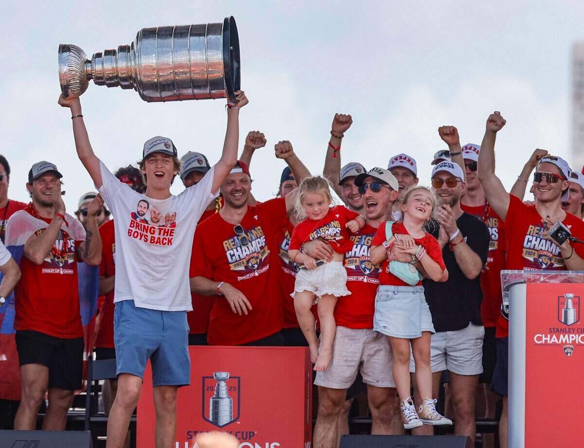 Florida Panthers center Brad Marchand celebrates with teammates and family on stage during the team’s Stanley Cup victory parade and rally along A1A in Fort Lauderdale, Florida, on Sunday, June 22, 2025.
