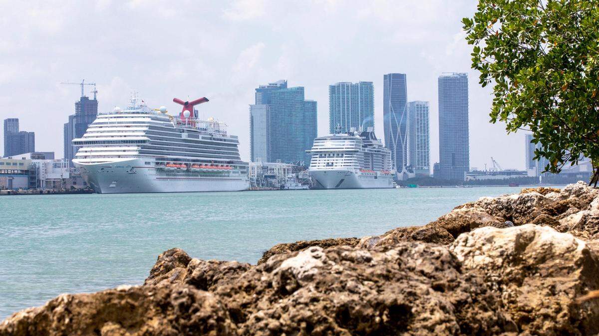 Cruise ships dock at PortMiami in April. One cruise line now wants to require COVID vaccines.