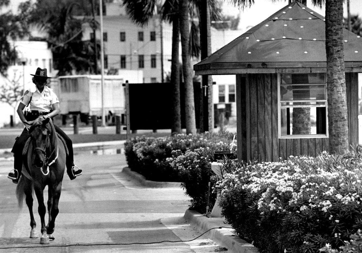 A mounted police officer rides past a parking booth t under construction at South Pointe Park in 1987.