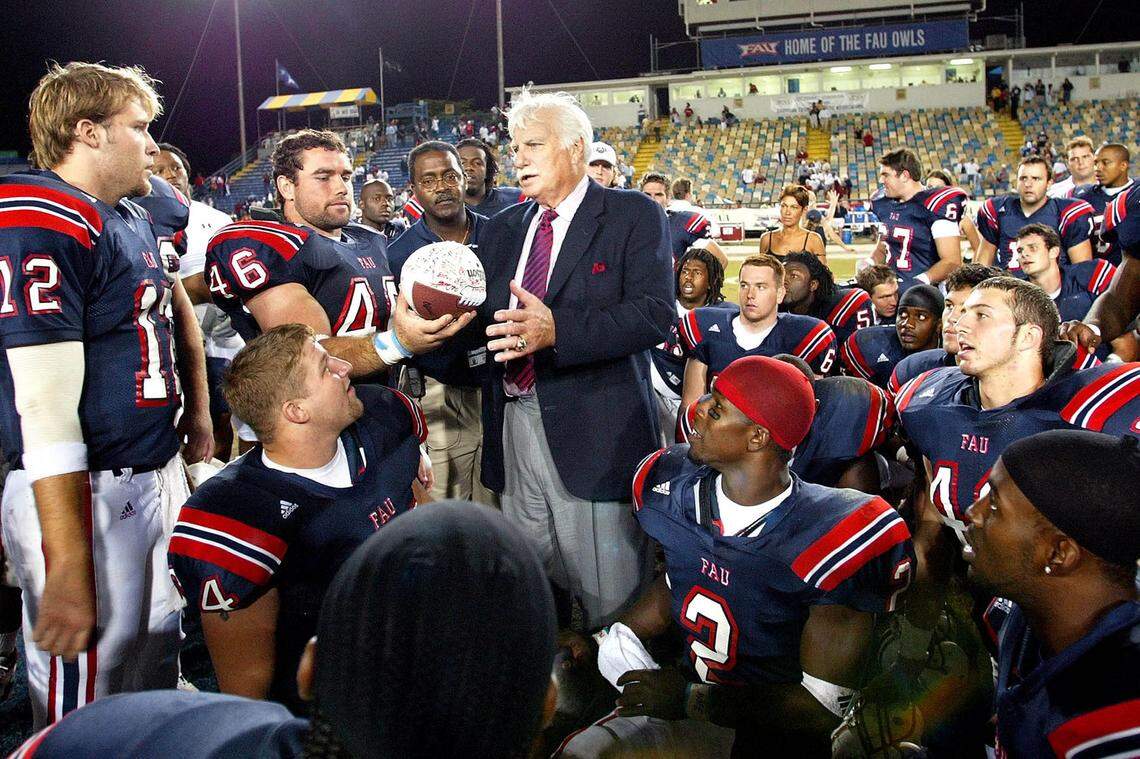 111503: Lockhart Stadium: (Spt): FAU vs Siena College: FAU quarterback Jared Allen, (12), and Chris Laskowski, 46, present a game ball with the players signatures to Head Coach Howard Schnellenberger as a gift for Schnellebergers oldest son Stephen who is battling cancer, at the conclusion of their game against Siena College, Saturday November 15, 03, in Ft. Lauderdale. Final score FAU 53, Siena 3. photo by Palm Beach Post--Staff Photograph Bill Ingram