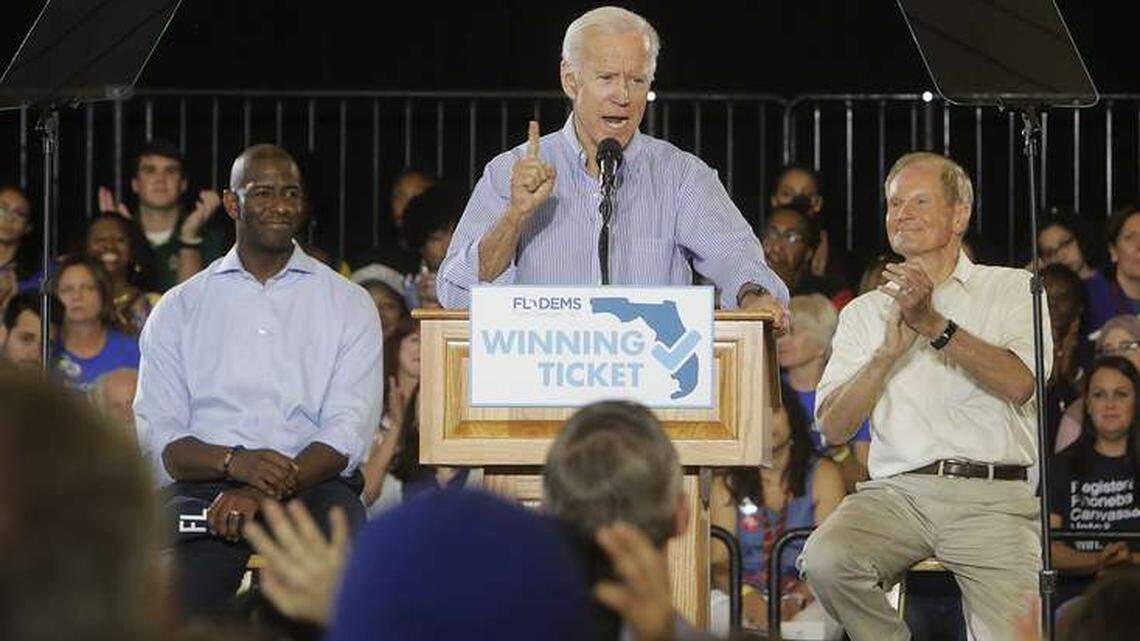 Former Vice President Joe Biden gives a speech to a packed gymnasium while Florida Democratic gubernatorial candidate Andrew Gillum, left, and U.S. Sen. Bill Nelson look on during the Florida Democratic Party rally at the University of South Florida in Tampa on Monday.