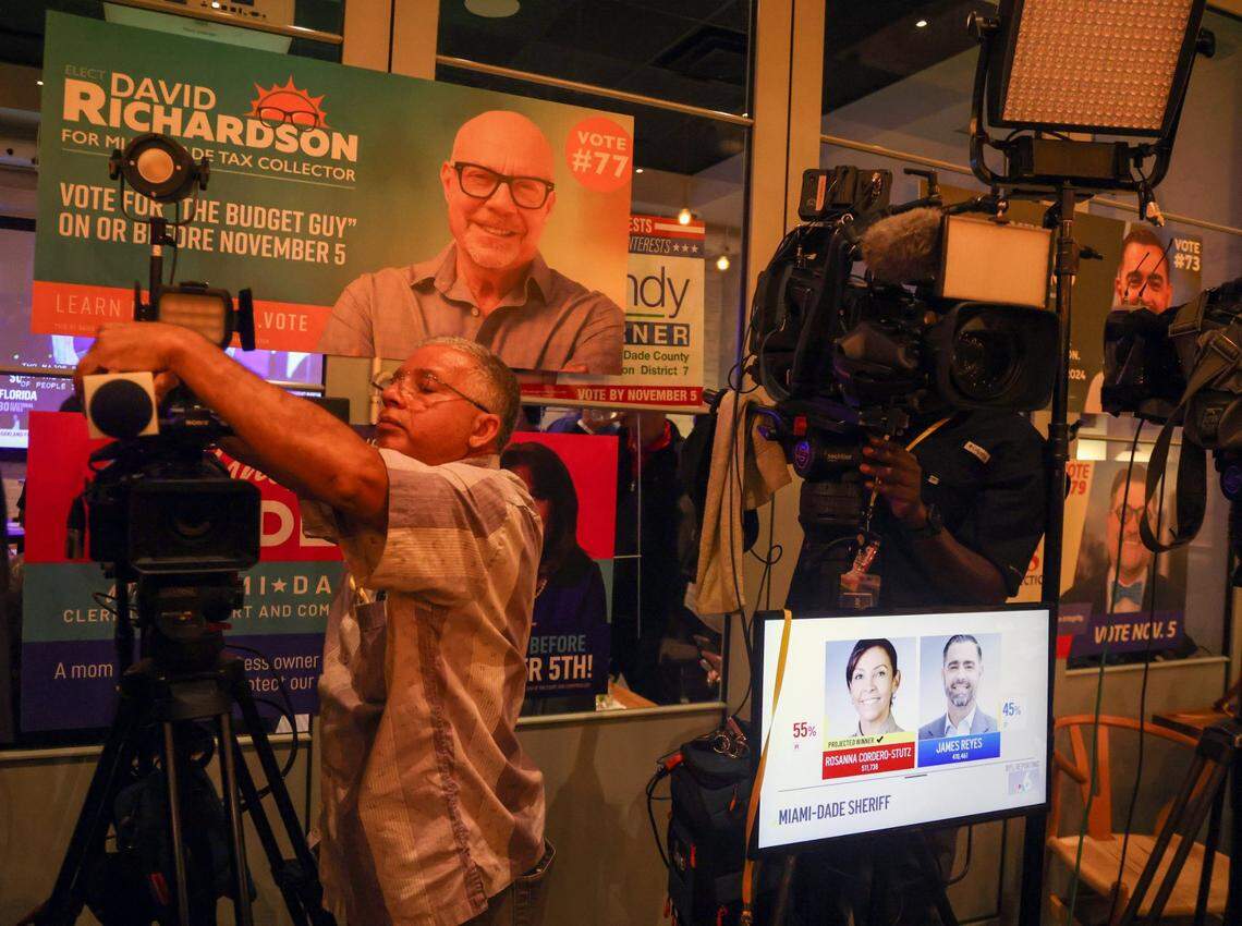 On a small screen, local Channel 6 broadcasts the result of the Miami-Dade Sheriff as television journalists pack their gear after James Reyes canceled his concession speech during the local Democratic Party election watch party at Bay 13 Brewery in Coral Gables, Florida, on Tuesday, November 5, 2024.