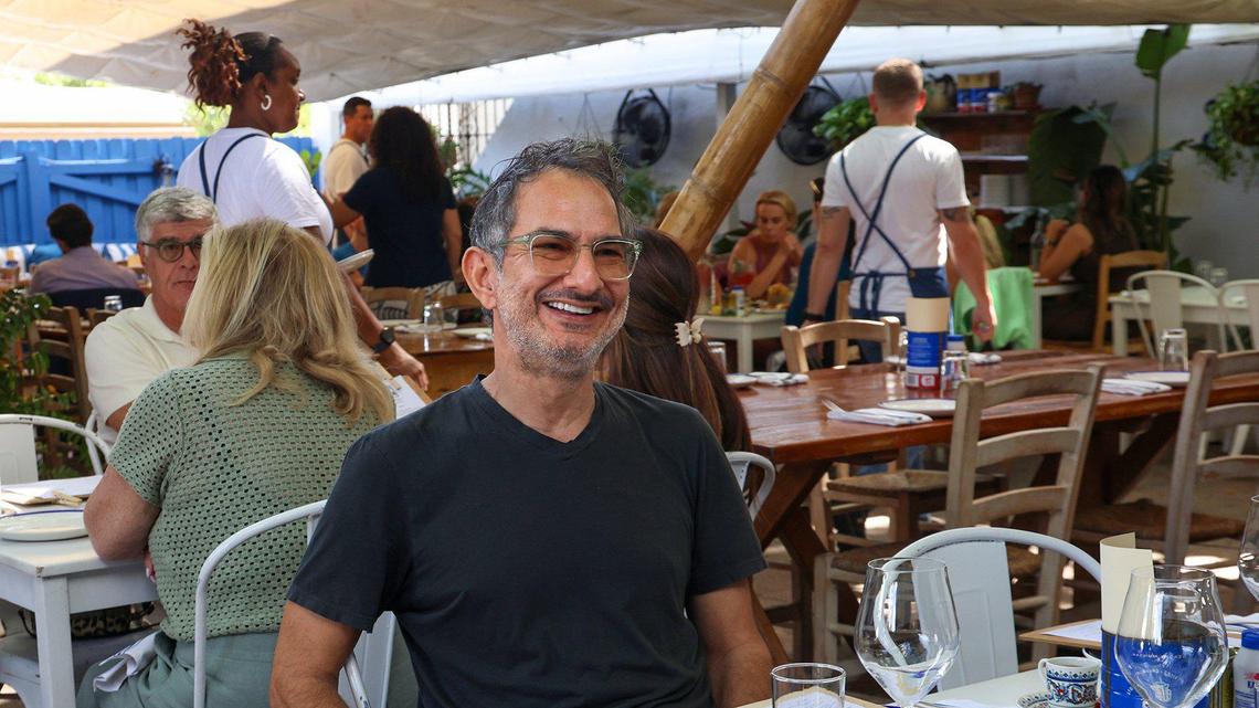 Ahmet Erkaya, co-founder of Mandolin Aegean Bistro, sits as a lunchtime crowd arrives at the Greek and Turkish restaurant celebrating its 15th anniversary.