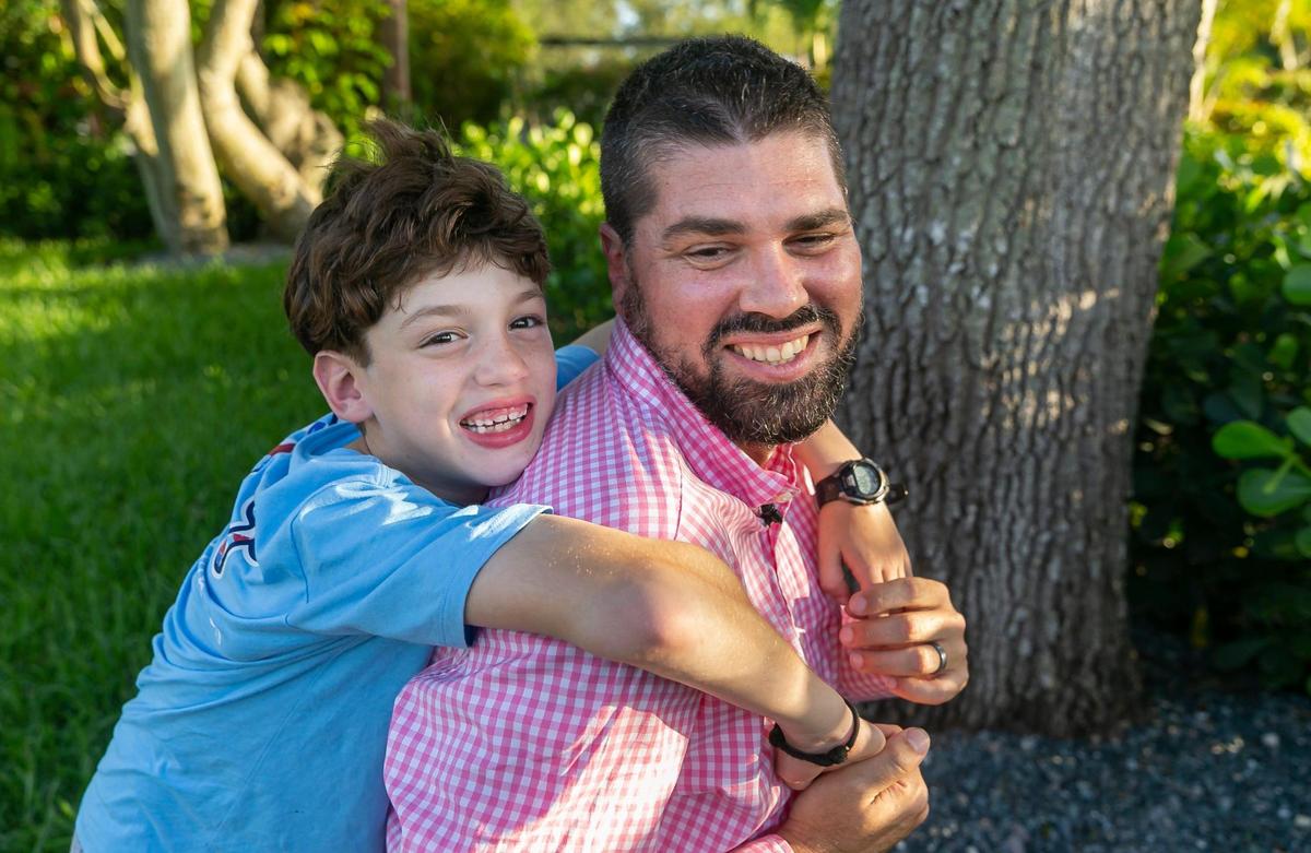 Pablo Rodriguez and his son, John Paul Rodriguez, are photographed at their home on Monday, June 13, 2022 in Miami, Fla. Pablo’s mom, Elena Blasser, and grandmother, Elena Chavez, were killed when the Champlain Towers South collapsed in Surfside on June 24, 2021.