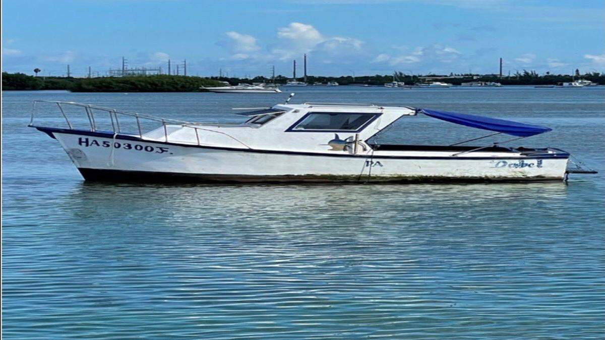 A Cuban fishing boat floats somewhere off the Florida Keys Thursday, Aug. 4, 2022. It was one of several vessels to bring more than 100 migrants to the island over a two-day period.