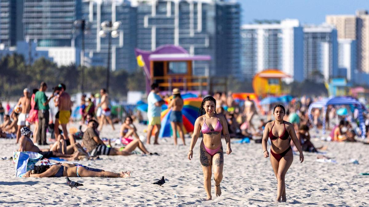 People lounge on South Beach during the fourth week of Spring Break in Miami Beach, Florida, on Saturday, March 25, 2023.