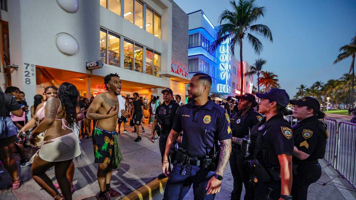 Last month, a man speaks with Miami Beach police officers after they confronted him on Ocean Drive during Spring Break on Miami Beach.