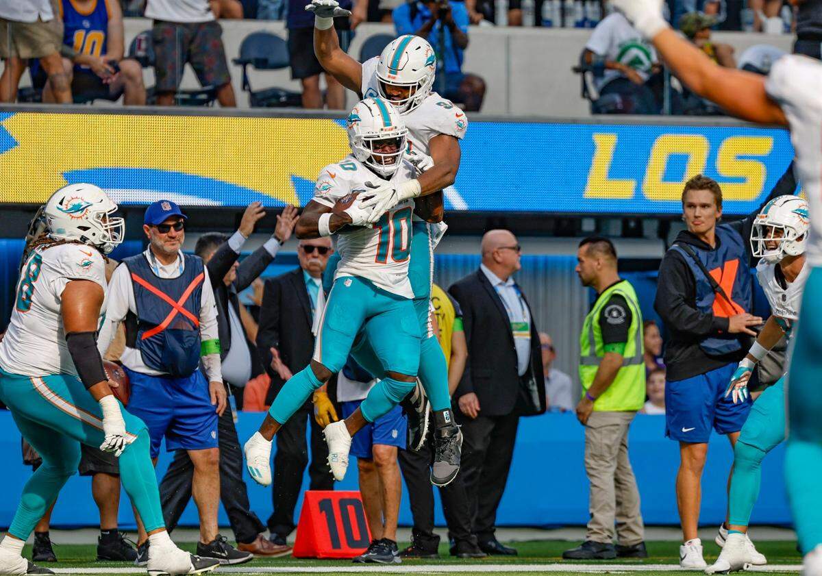 Miami Dolphins wide receiver Tyreek Hill (10) and Miami Dolphins defensive tackle Christian Wilkins (94) celebrate Hill’s touchdown late in the fourth quarter against the Los Angeles Chargers at SoFi Stadium in Inglewood, California on Sunday, September 10, 2023.