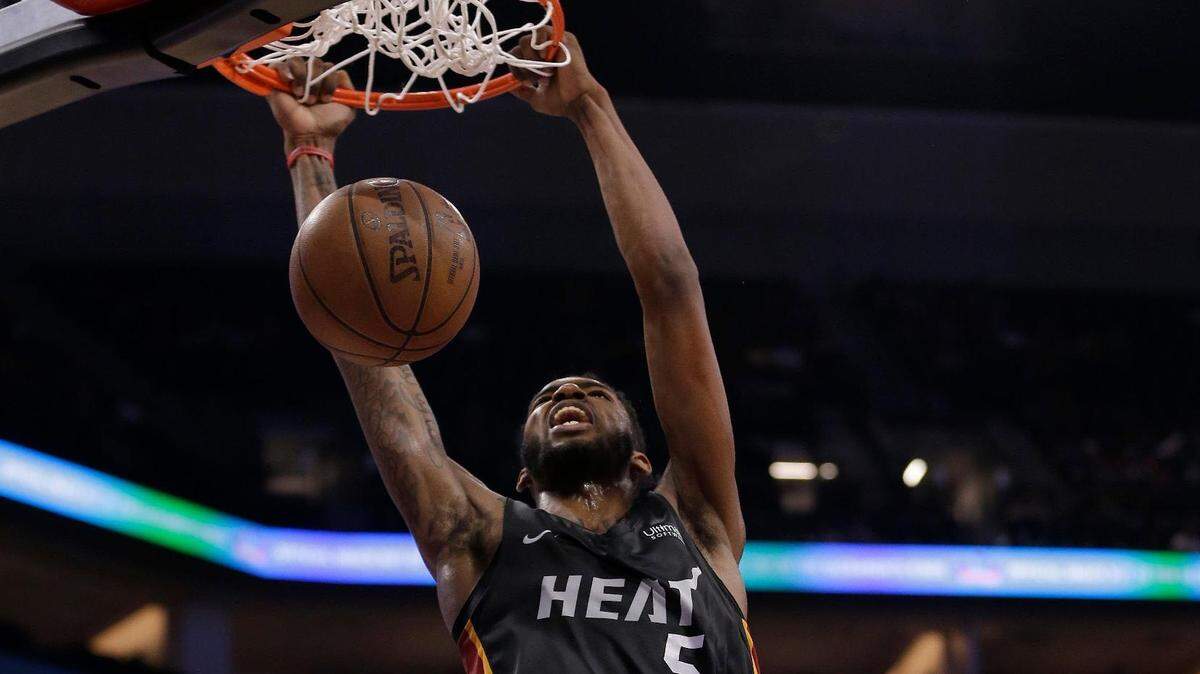 Miami Heat forward Derrick Jones Jr. dunks as Sacramento Kings forward Marvin Bagley III, right, watches during the first half of an NBA summer league basketball game Thursday, July 5, 2018, in Sacramento, Calif. (AP Photo/Rich Pedroncelli)