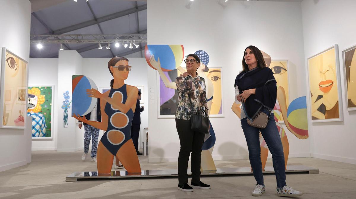 Sara Adler, left, and Vicki Miller admire artwork outside of the David Benrimon gallery booth filled with Alex Katz’s work during the opening night of VIP for Art Miami on Tuesday, Nov. 29, 2022, at CONTEXT Art Miami.