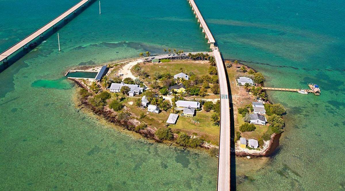 Pigeon Key, the one-time base camp for the workers that constructed Henry Flagler’s Florida Keys Over-Sea Railroad is both an educational center and a visitor attraction featuring a small museum that pays homage to railroad that opened in January 1912 and ceased operations in September 1935. Flaglers’ original Seven Mile Bridge bisects the island on the right, while today’s modern day bridge is on the left.