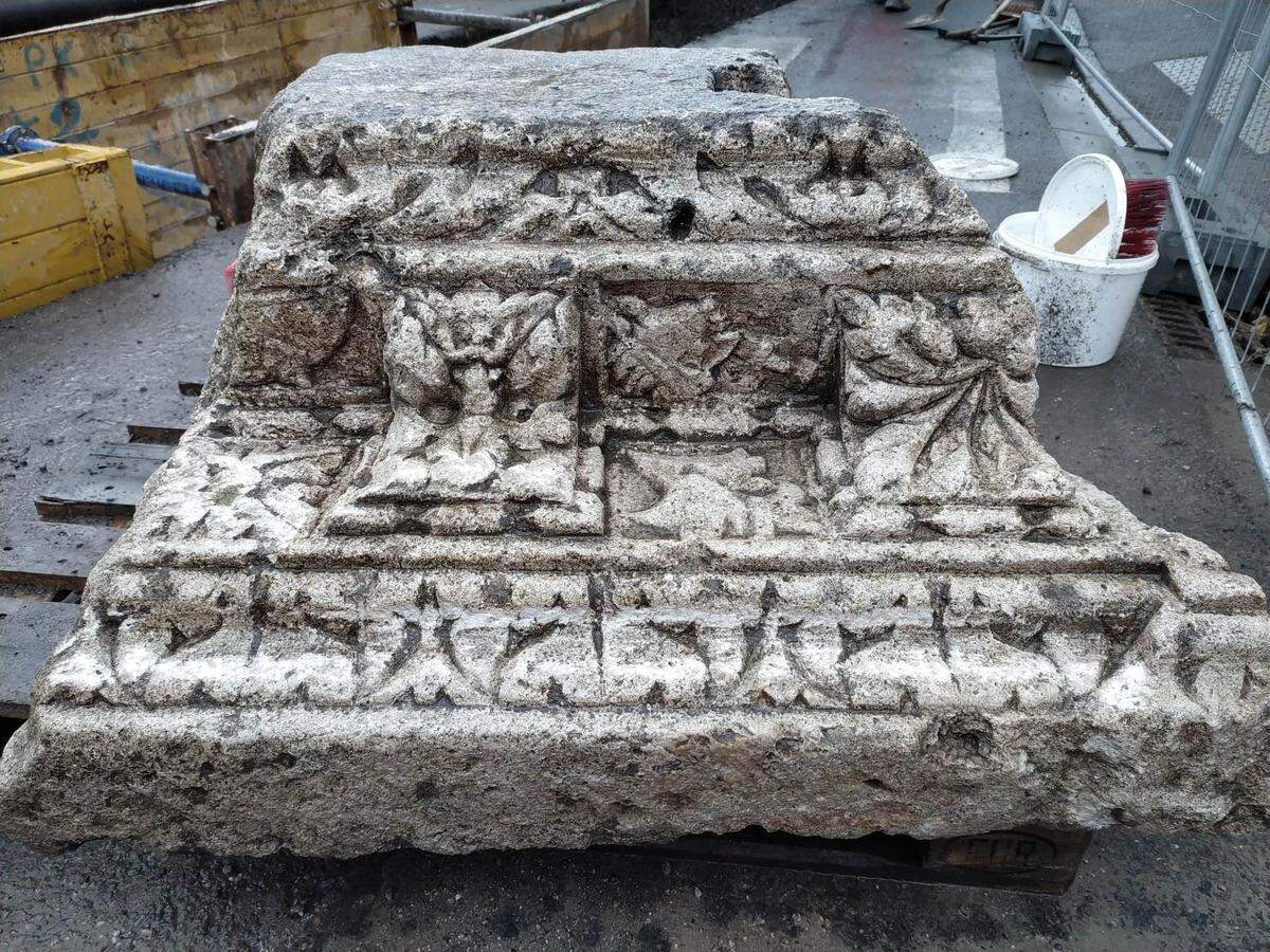 The 800-pound piece of stone was likely on a monumental building before it was broken to use in the defensive wall.