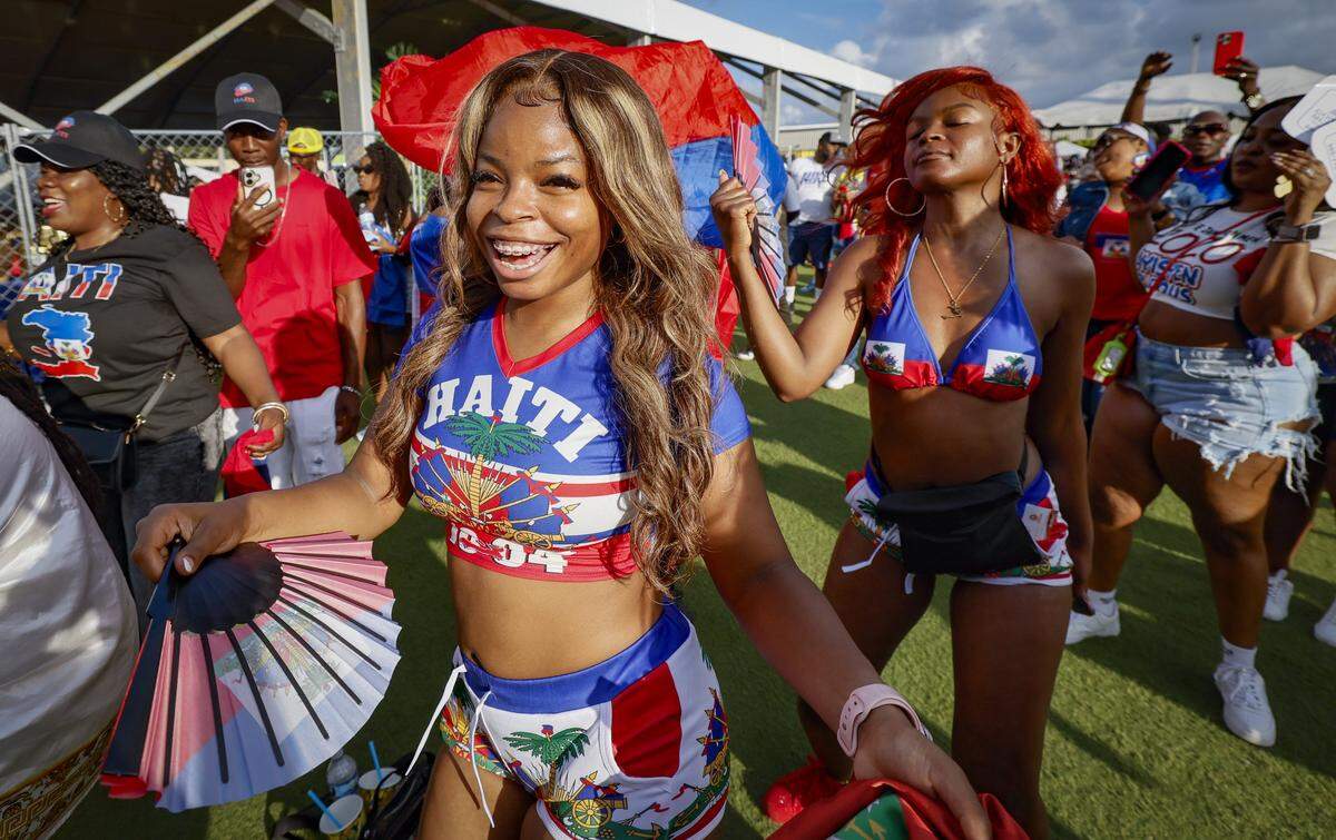 Sisters, Aryane and Yamilce Aurelien dance to the music during the 28th Annual Haitian Compas Festival at The NoMI Village celebrating Haitian Flag Day, in North Miami, Florida  on Saturday, May 16, 2026.