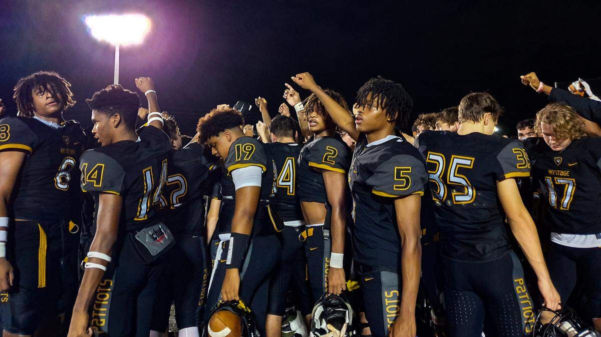 The Plantation American Heritage football team huddles together after defeating Cardinal Gibbons 23-17 on Friday, Oct. 30, 2020.