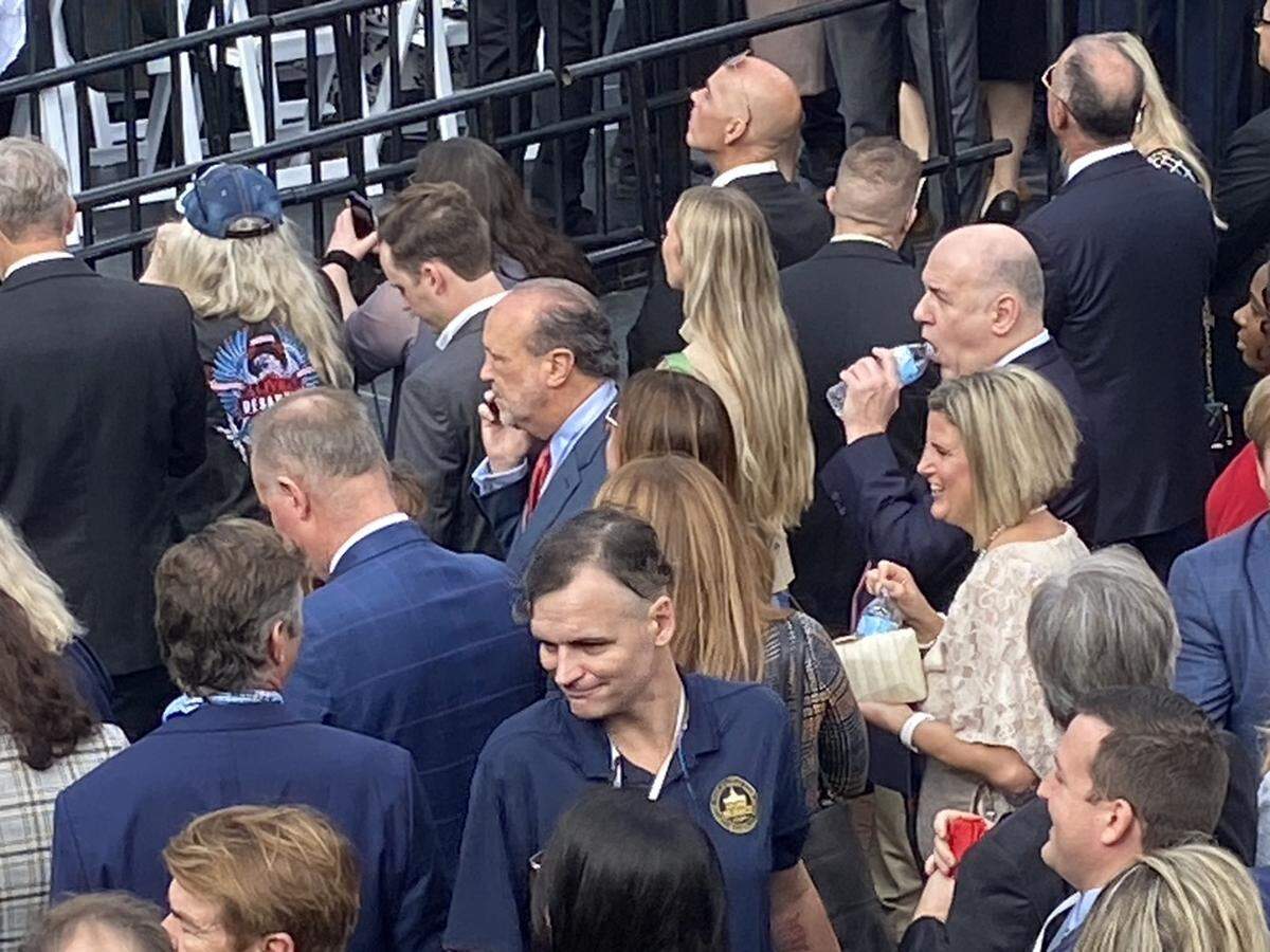 When organizers ran out of seats for the swearing in of Gov. Ron DeSantis, an overflow crowd that included donors and legislators waited in the back. Pictured in the center is Miami lobbyist Ron Book, one of the inauguration sponsors, on the phone.