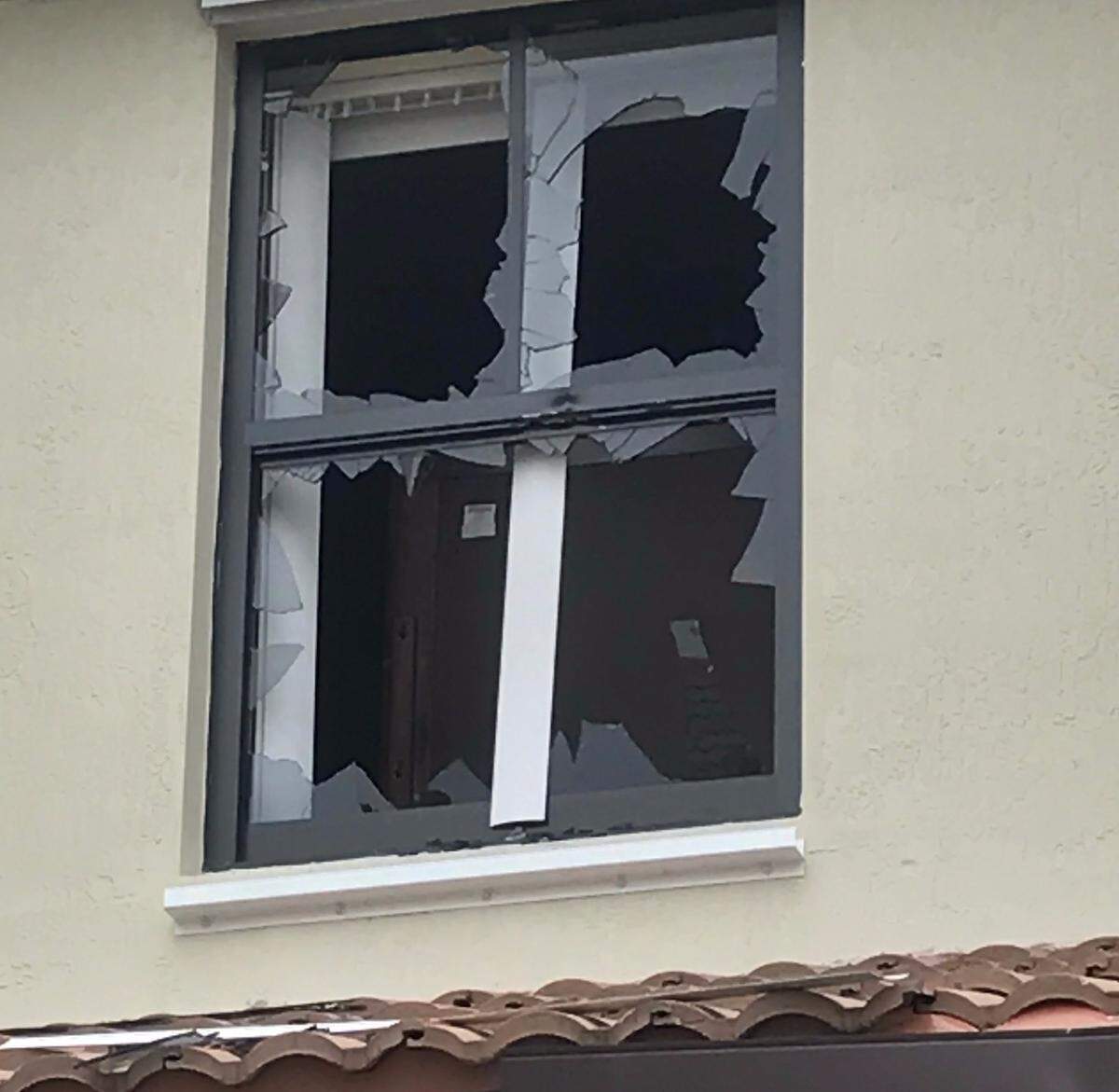 A broken second-story window of a townhouse at SW 117th Court in southwest Miami-Dade County following an hours-long standoff between Miami-Dade police and a man who fatally shot a woman and then himself Monday morning, Sept. 10, 2018.
