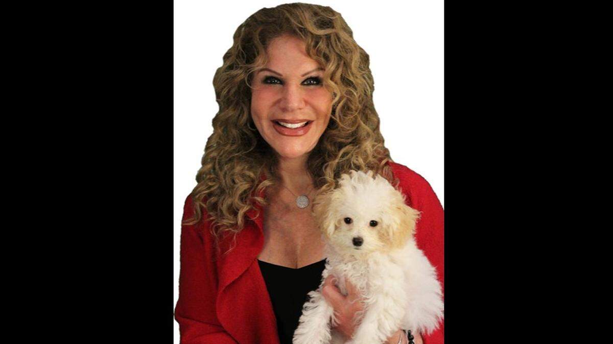 The late Miami real estate broker Linda Marx was known for her trademark ads in which she held a small white dog.