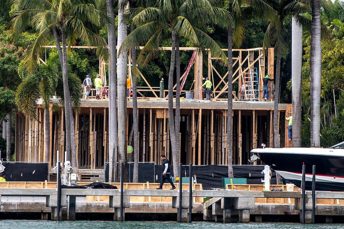 Construction workers seen working on a mansion in Miami Beach, on Jan. 26, 2022.